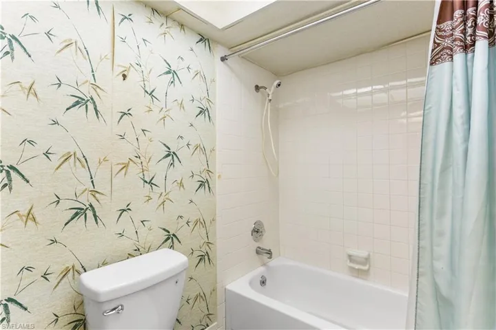 Bathroom featuring shower / bath combo and toilet