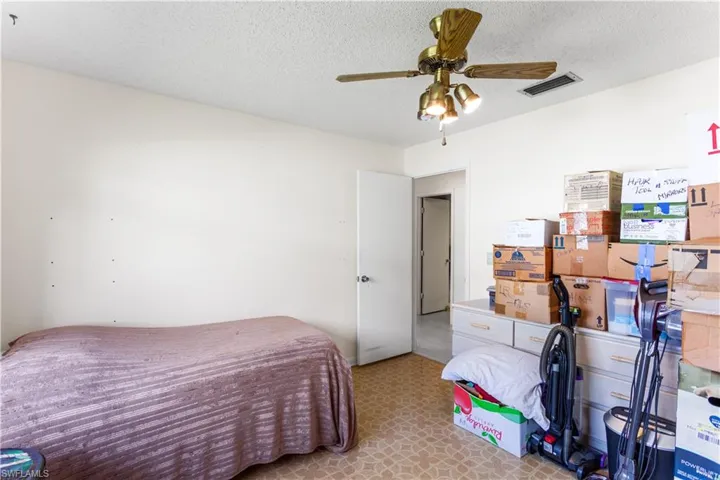 Bedroom featuring ceiling fan and a textured ceiling