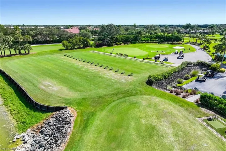 Drone / aerial view of a tree filled landscape and a golf club