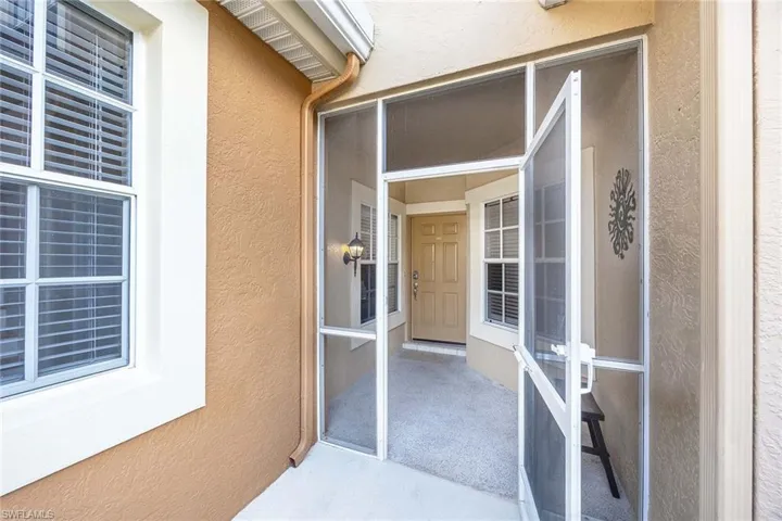 Doorway to property with stucco siding
