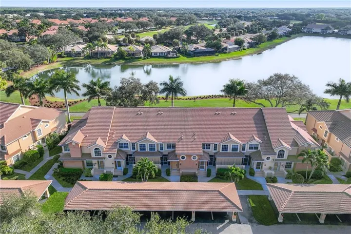 Aerial view of residential area featuring a nearby body of water