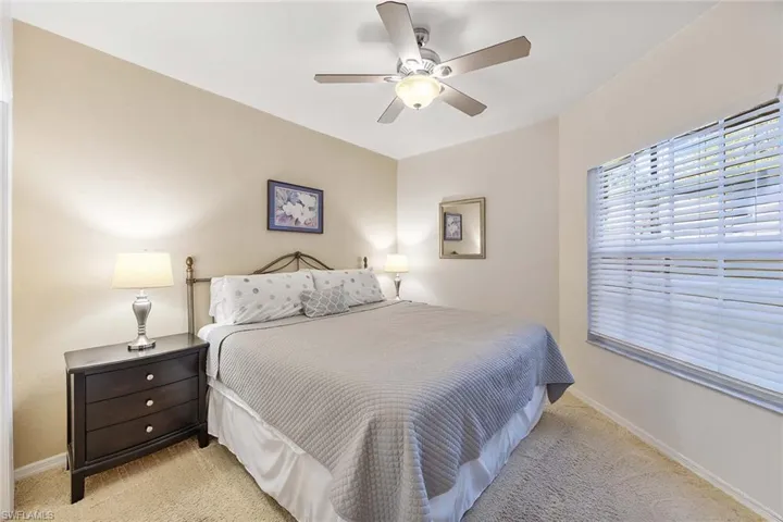 Bedroom featuring a ceiling fan and light carpet