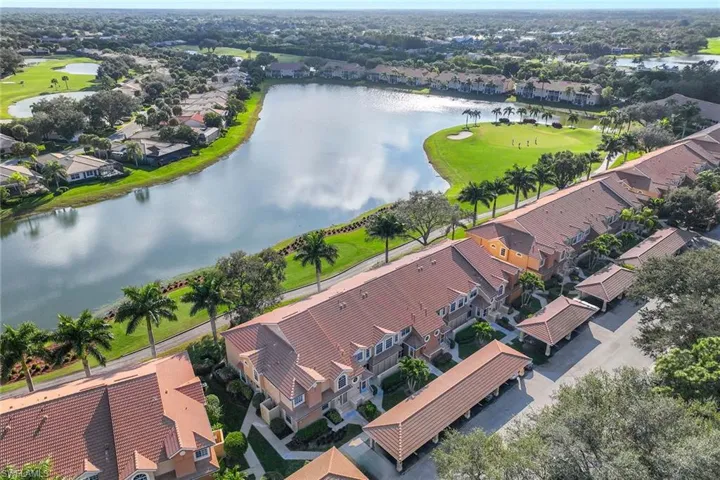 Aerial view of residential area featuring a large body of water and a local golf course