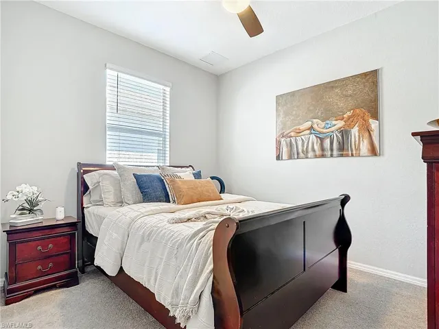 Bedroom with ceiling fan, carpet floors, visible vents, and baseboards