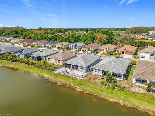 Drone / aerial view with a residential view and a water view