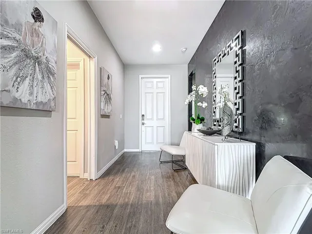 Entryway featuring baseboards and wood finished floors
