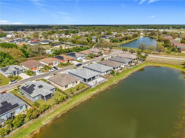 Drone / aerial view with a residential view and a water view