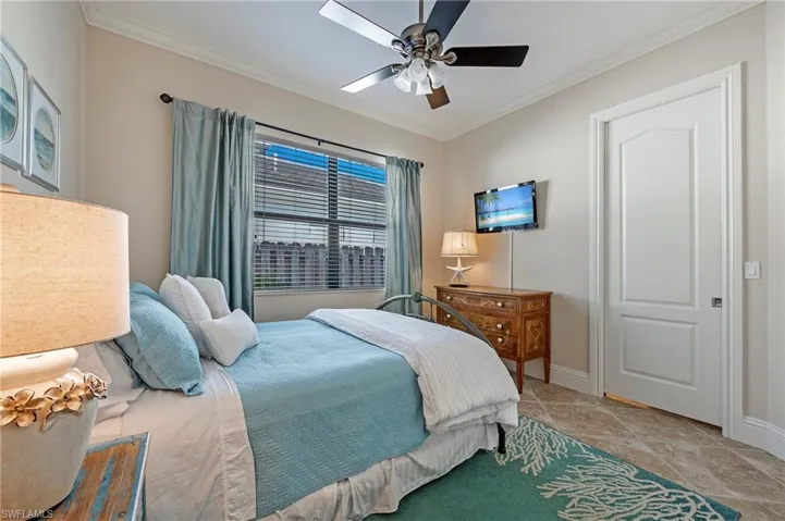 Guest bedroom #2 featuring crown  molding and ceiling fan