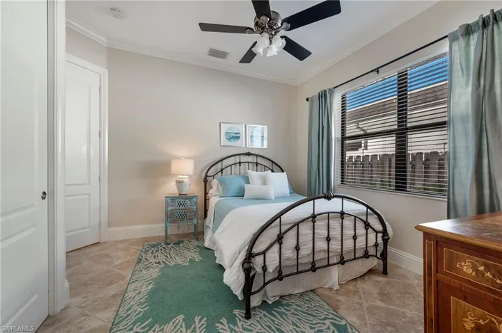 Guest bedroom #2 featuring crown  molding and ceiling fan