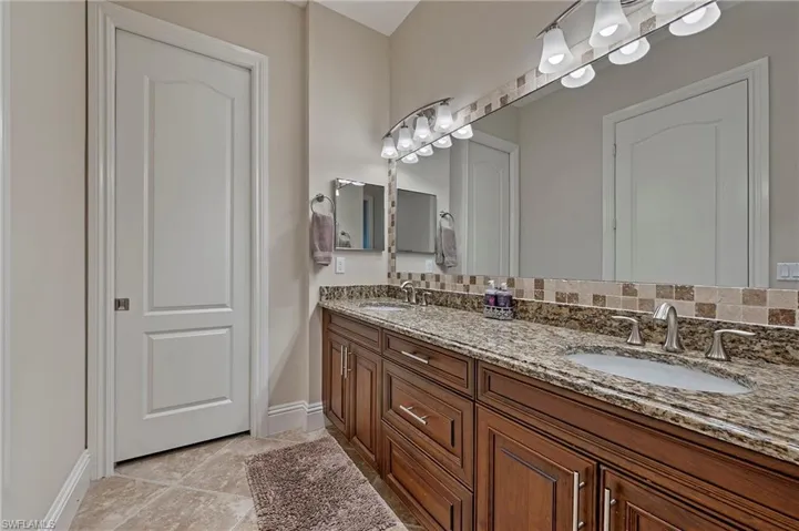 Primary Bathroom with vanity and porcelain tiled floors