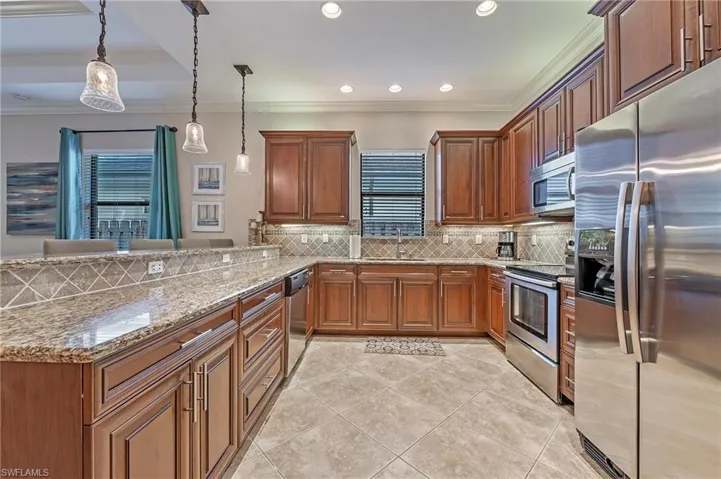 Kitchen with stainless steel appliances, granite counters and wood cabinetry