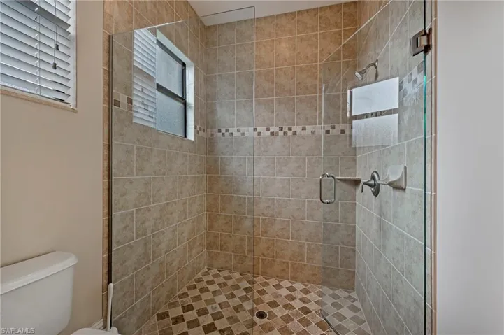 Primary Bathroom featuring toilet and walk in shower