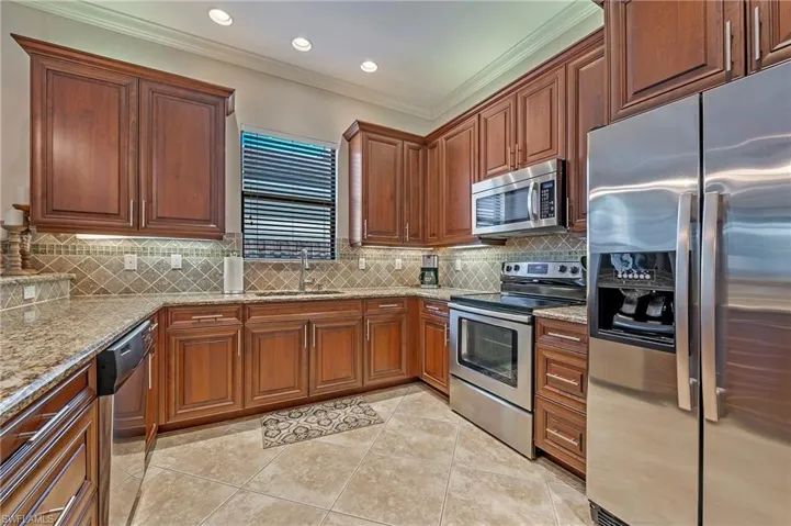 Kitchen with stainless steel appliances, granite counters and wood cabinetry