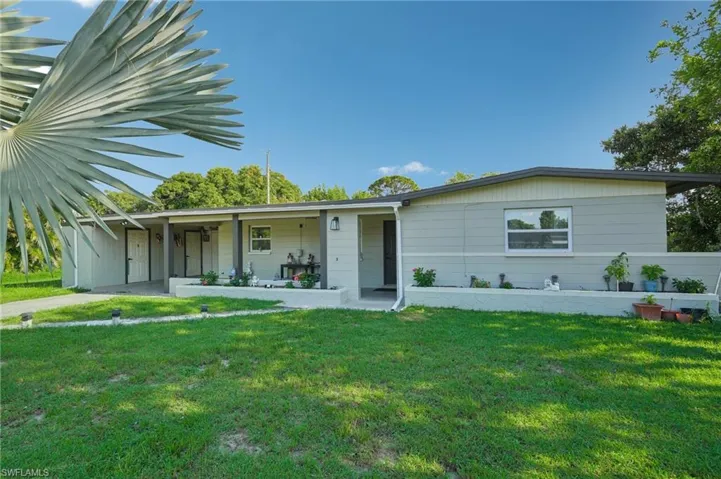Single story home featuring a front lawn