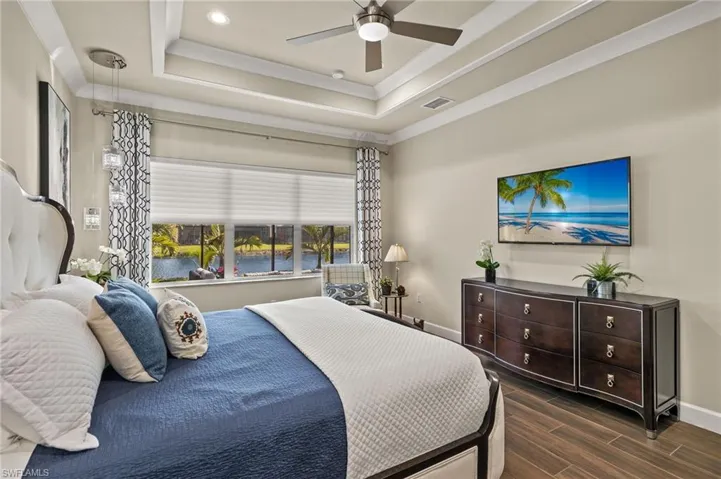 Wake up to a gorgeous lake view from this primary bedroom every morning!