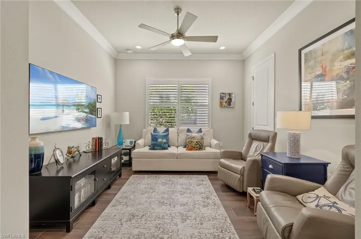 Cozy den with navy barn doors, plantation shutters, closet and beautiful updated flooring (throughout home).