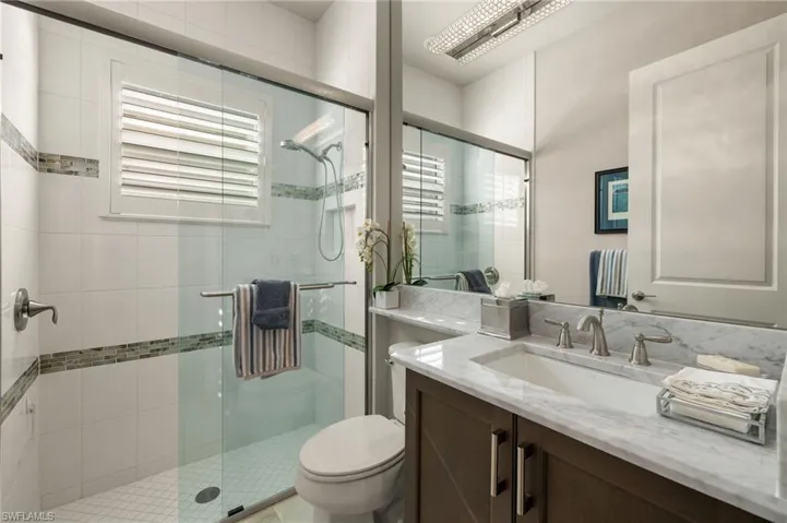 Guest bathroom...walk-in shower + featuring floor to ceiling tiles.