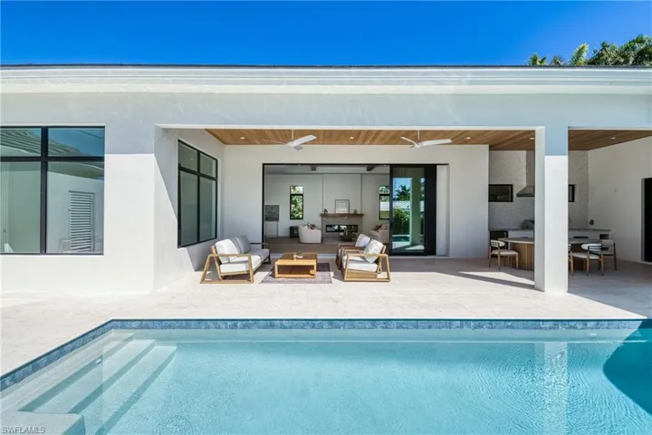Outdoor pool featuring a patio area, an outdoor living space, outdoor dining area, and a ceiling fan