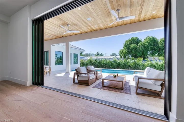View of patio / terrace featuring an outdoor living space, a ceiling fan, and a fenced in pool