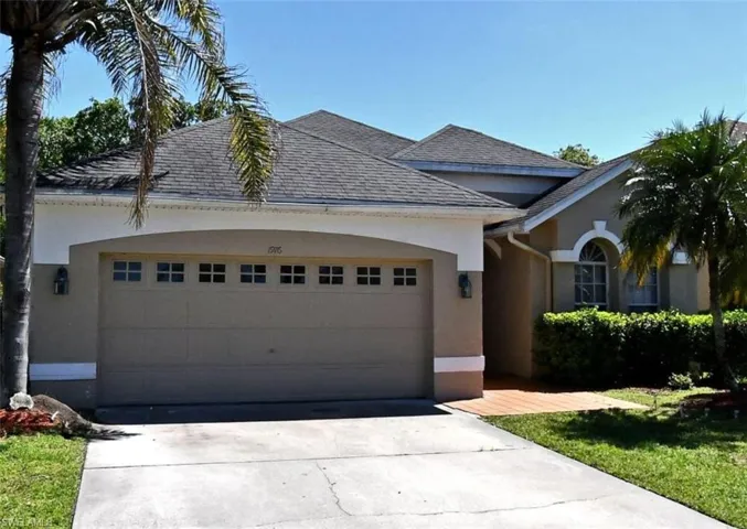 View of front of property featuring stucco siding, driveway, an attached garage, and roof with shingles
