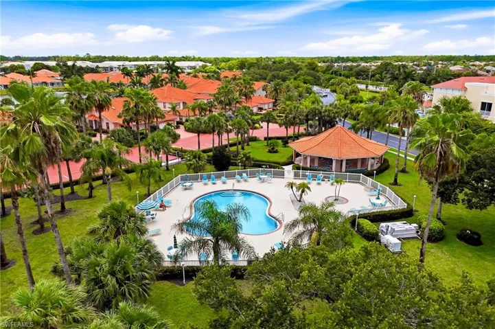 Elevated views showcase the sparkling community pool, clubhouse, and beautifully landscaped grounds.
