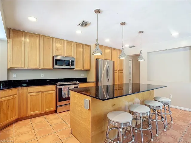 Bright, open concept eat-in kitchen layout with center island.
