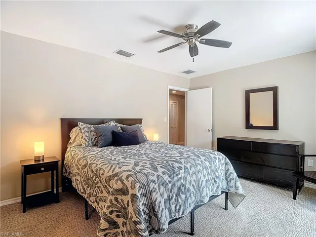 Carpeted master bedroom with ceiling fan