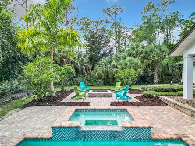 View of swimming pool with an in ground hot tub, a patio, and an outdoor fire pit
