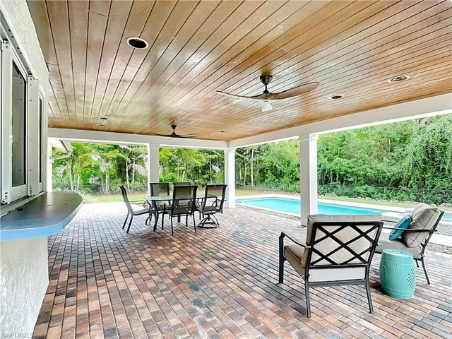 View of covered Veranda featuring wood ceiling.