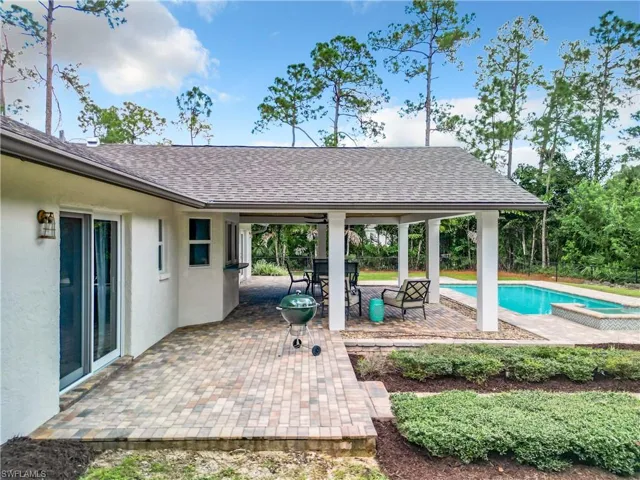 View of pool featuring a patio and a jacuzzi