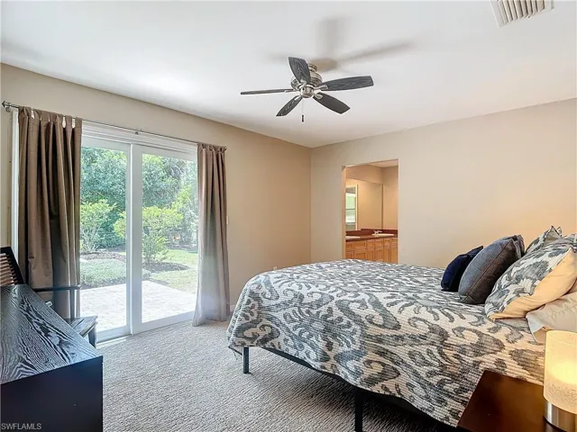Generous sized master suite with light carpeting, beautiful view of back yard with access to paver patio and tiled master bathroom.