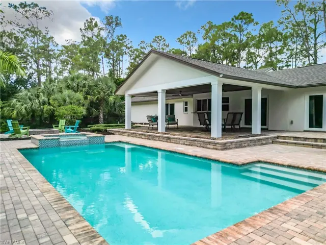View of swimming pool featuring an in ground hot tub, ceiling fan, and a patio area