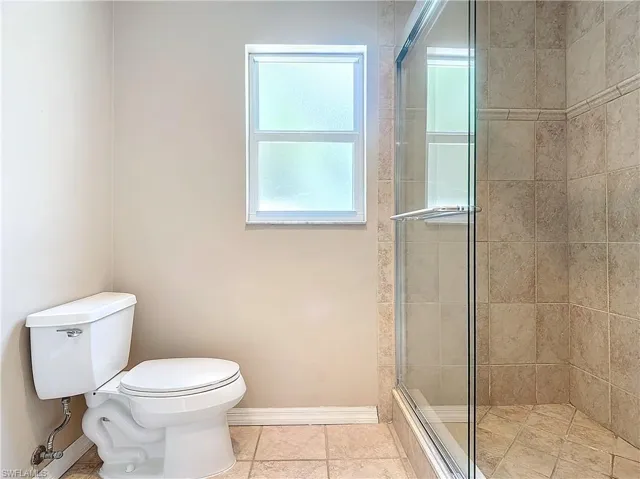 Bathroom featuring enclosed toilet and an shower