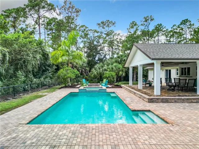 View of swimming pool featuring a patio and ceiling fan