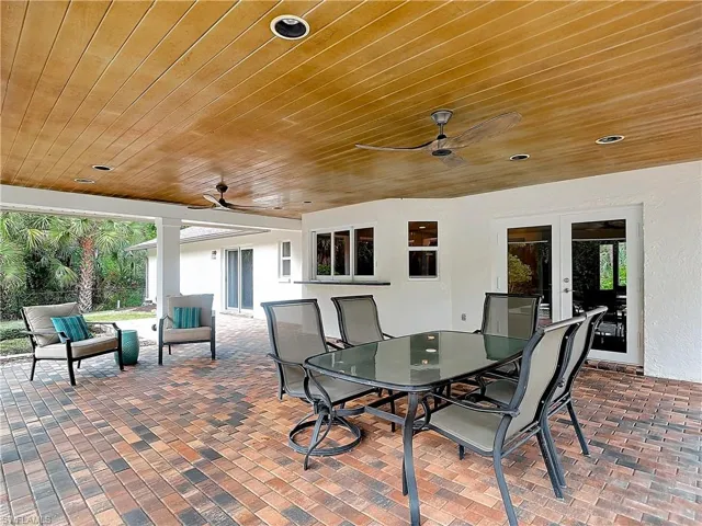 French doors lead to covered Veranda overlooking pool & spa. A perfect setting for family gatherings or entertaining guests.