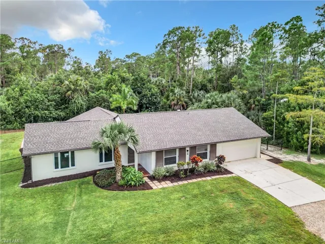 Ranch 3 bed 2 bath style home with a garage and a beautiful yard.