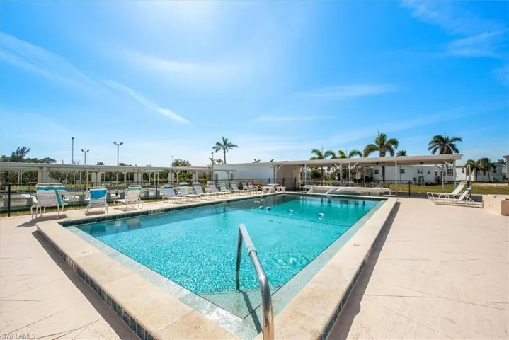 Community pool with a patio