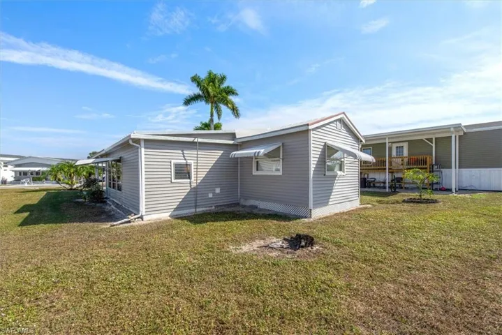 Rear view of property featuring a lawn