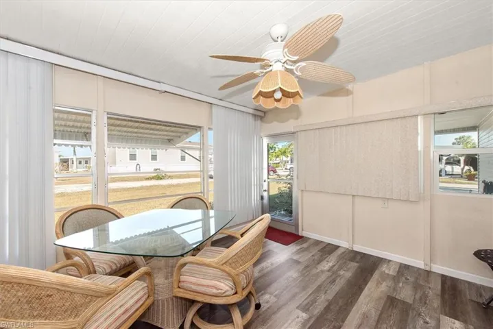 Dining room with wood finished floors and ceiling fan