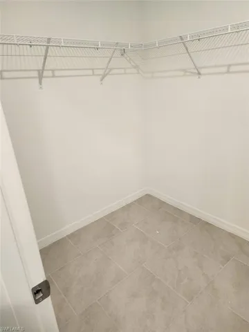Walk in closet featuring light tile patterned floors