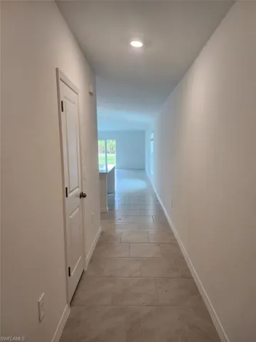 Corridor featuring baseboards