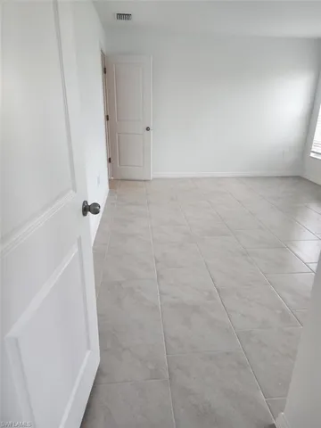 Spare room with light tile patterned flooring
