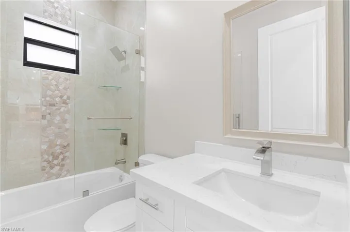 Full bathroom featuring vanity, toilet, and tiled shower / bath