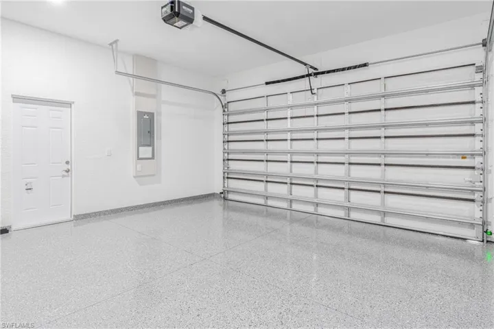 Garage with a garage door opener and electric panel