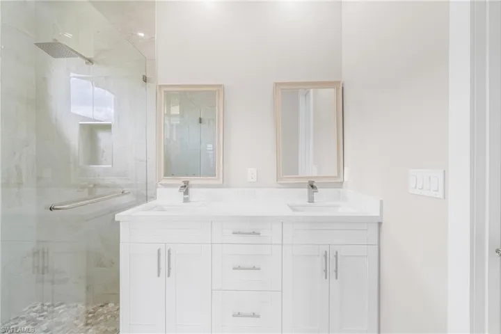 Bathroom featuring vanity and an enclosed shower