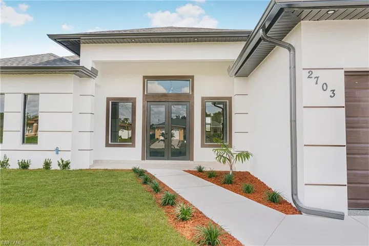 Property entrance with french doors and a yard