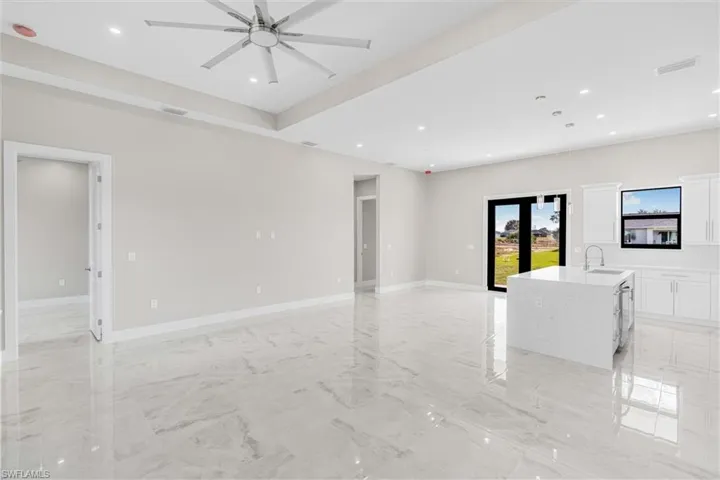 Unfurnished room with sink and ceiling fan