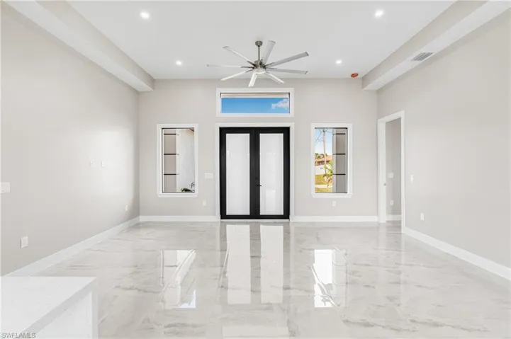 Foyer entrance featuring ceiling fan and french doors