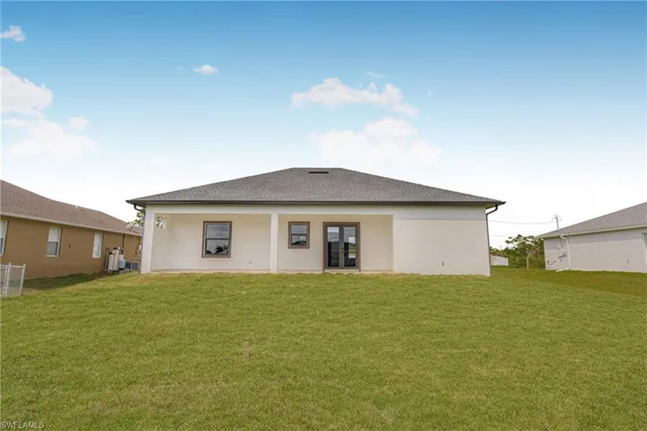 Rear view of property featuring a yard