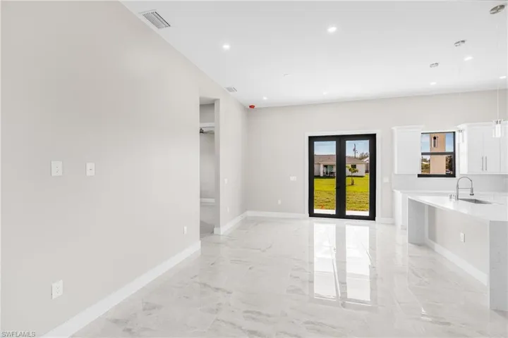 Empty room with french doors and sink